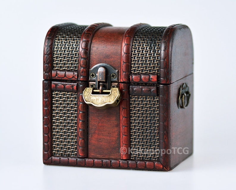May include: A small, wooden treasure chest with a brown stain and a woven pattern on the front and sides. The chest has a brass latch and a metal handle.