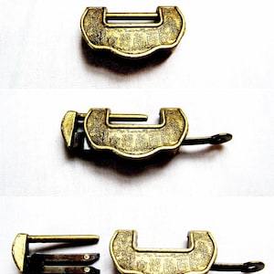 May include: A set of three antique brass locks with intricate designs and Chinese characters. The locks are in various positions, showing the keyhole, the lock mechanism, and the key.