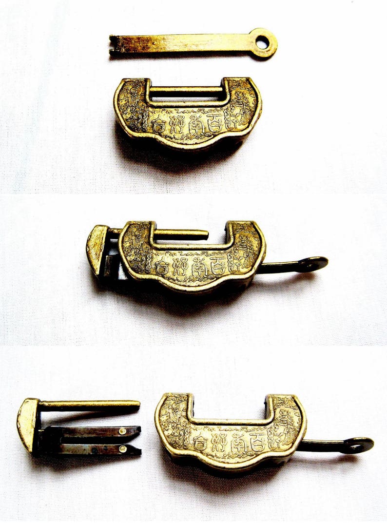 May include: A set of three antique brass locks with intricate designs and Chinese characters. The locks are in various positions, showing the keyhole, the lock mechanism, and the key.