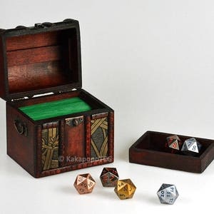 May include: A wooden treasure chest with a green felt lining, open to reveal a set of metal dice. The dice are in a separate wooden tray.