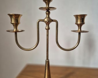 A classic brass chandelier with three arms, probably intended for interior decoration