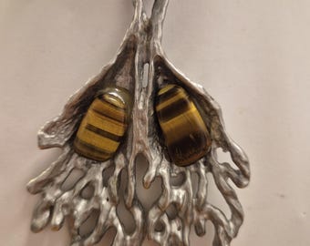 A necklace in a nature-inspired/organic style with stones like tiger's eye, Swedish Designed