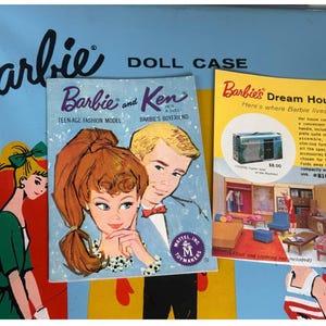 May include: Two vintage Barbie doll product brochures. The left brochure features a color illustration of Barbie and Ken, with the text "Barbie and Ken, Teen Age Fashion Model, Barbie's Boyfriend". The right brochure features a color illustration of a Barbie Dream House, with the text "Barbie's Dream House, Here's where Barbie lives!" and a price of $38.00.