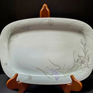May include: White oval serving platter with a raised rim and a delicate floral design in shades of green and purple.