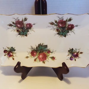 May include: White rectangular serving tray with a gold rim and a floral design featuring red, pink, and green roses.