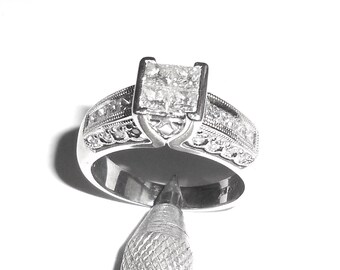 May include: A silver engagement ring with a large square-cut diamond center stone and smaller diamonds set in the band.