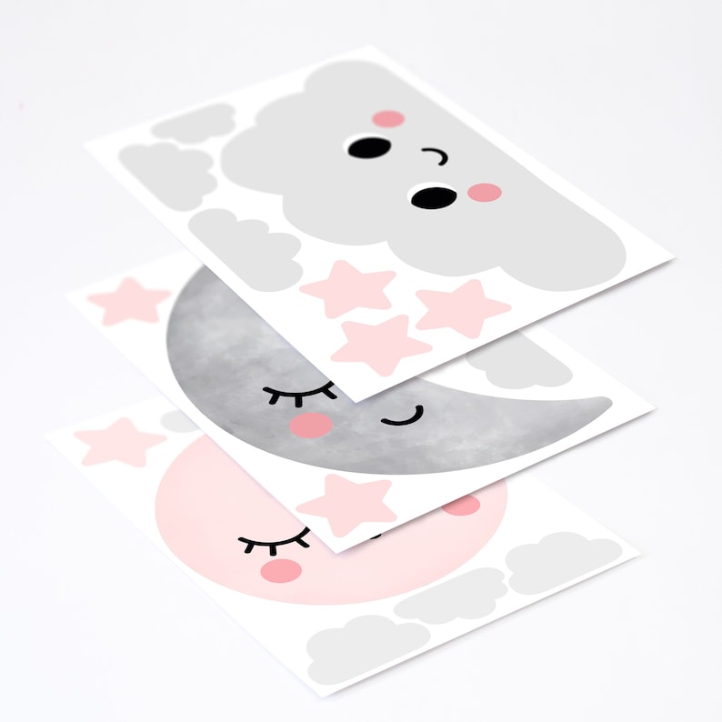 May include: Three sheets of wall decals featuring a pink and gray moon, a pink moon, and a gray cloud with pink cheeks. Each decal has a smiling face with closed eyes and eyelashes. The cloud decal also has three pink stars.