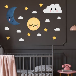 May include: A nursery wall decal set featuring a yellow sun, a blue crescent moon, a white cloud with a smiling face, and yellow stars. The decals are perfect for a baby's room or a child's bedroom.