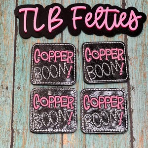 May include: Four black square patches with white stitching around the edges. Each patch has the words "Copper Boony!" in pink lettering.