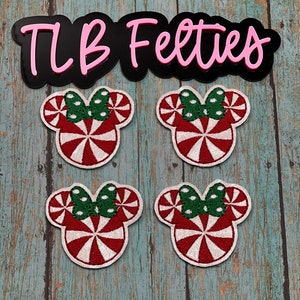 May include: Four red and white peppermint candy cane themed felt Mickey Mouse head appliques with green bows. The appliques are on a wooden background with the text "TLB Felties" in pink letters on a black background.