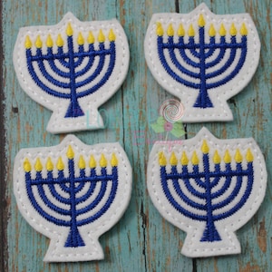 May include: Four white felt patches with blue and yellow embroidered menorahs. Each menorah has nine candles, with the center candle being the shamash.