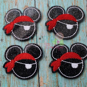 May include: Four black and white glitter iron-on patches with red and white pirate Mickey Mouse heads. Each patch features a red bandana and a white eye patch.