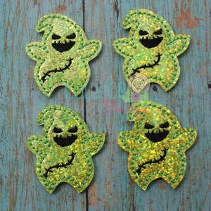 May include: Four green and yellow glittery ghost appliques with black stitched details. The ghosts have a stitched-on smile and eyes.