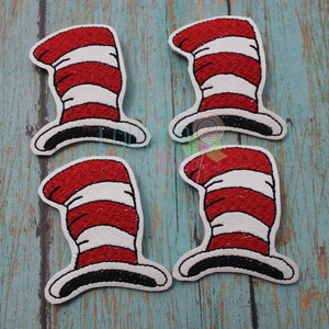 May include: Four red and white striped felt appliques shaped like the iconic hat from the book "The Cat in the Hat".