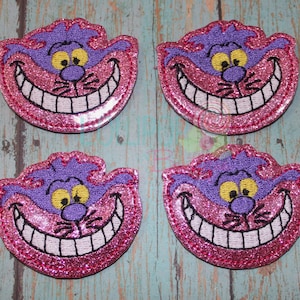 May include: Four pink and purple glitter iron-on patches featuring the Cheshire Cat from Alice in Wonderland. Each patch has a wide, toothy grin and yellow eyes.