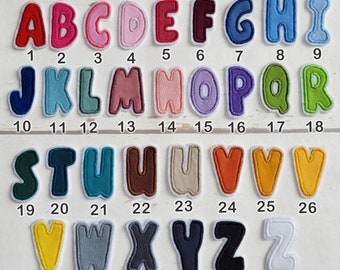 May include: A set of 32 colorful felt alphabet letters, each with a white outline. The letters are arranged in rows, with numbers 1-32 below each letter.