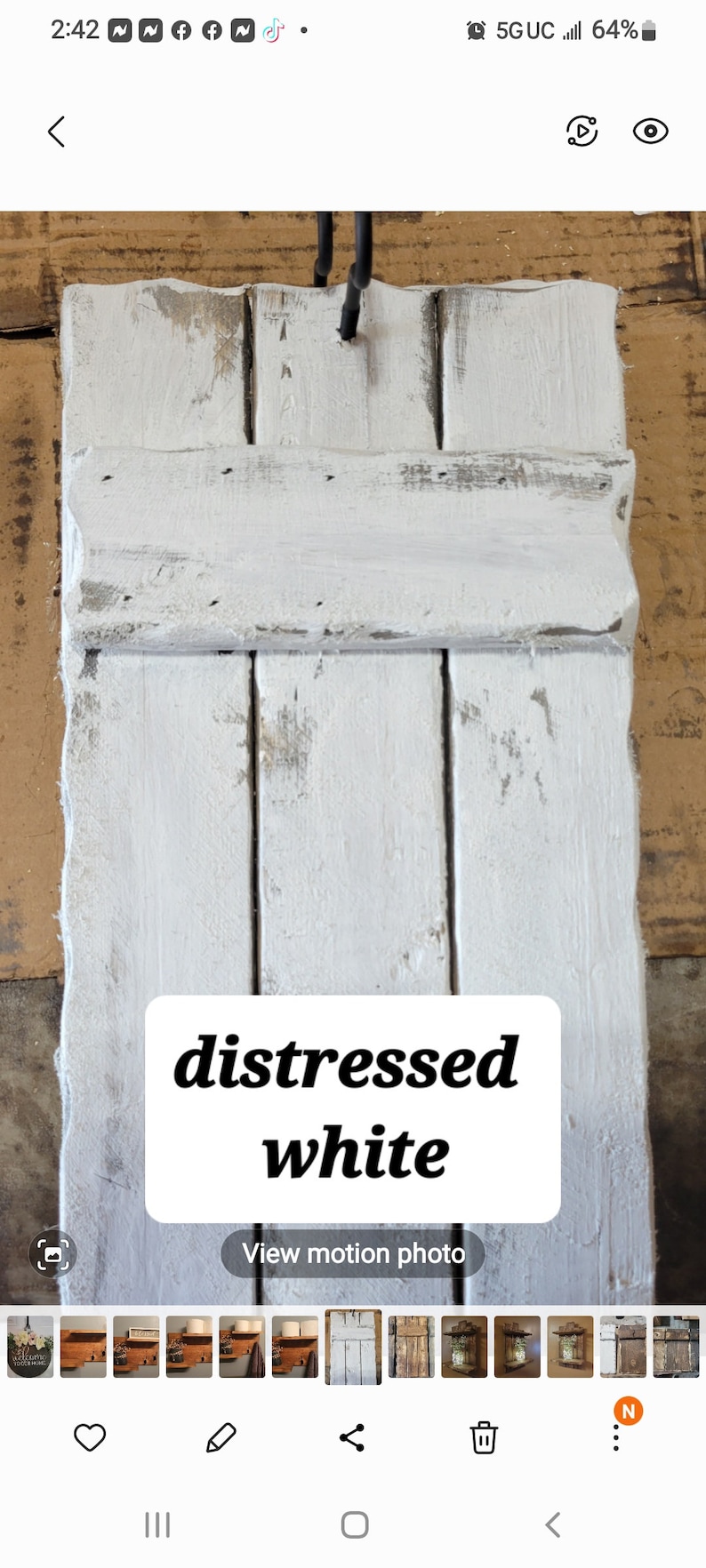 May include: Distressed white wooden shutters with a rustic, weathered look. The shutters are painted white with a distressed finish, giving them a vintage feel.