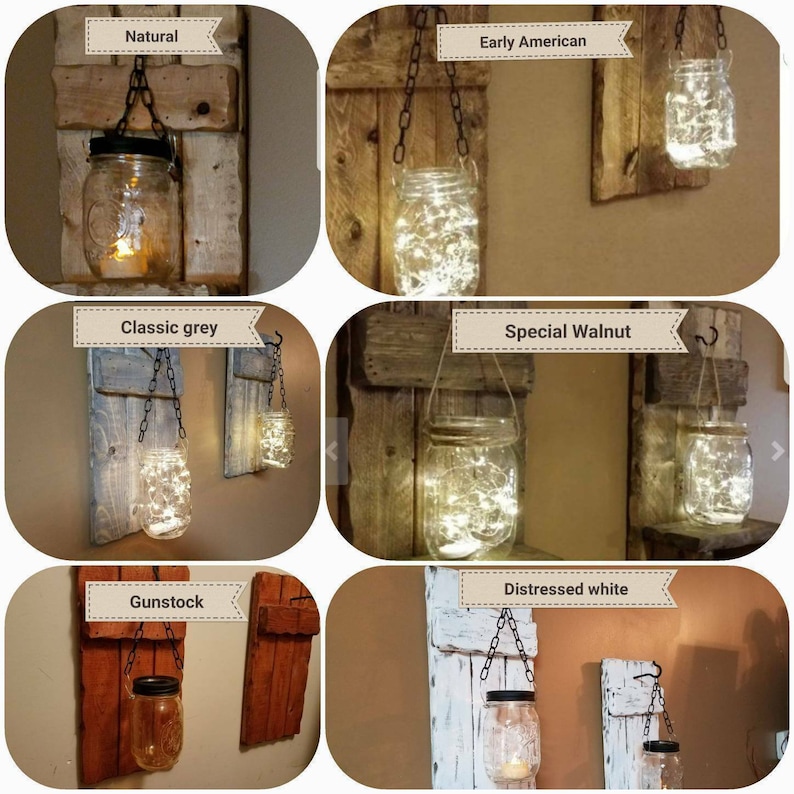May include: Six different wood wall sconces with mason jars hanging from chains. The mason jars are lit with fairy lights. The wood finishes are: Natural, Early American, Classic Grey, Special Walnut, Gunstock, and Distressed White.