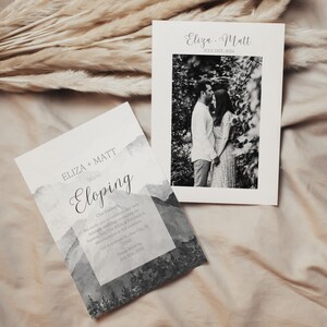 May include: A wedding announcement card with a watercolor mountain background. The card says "Eliza + Matt We're Eloping" and includes the date "July 23, 2024". A separate card with a black and white photo of the couple is also shown.