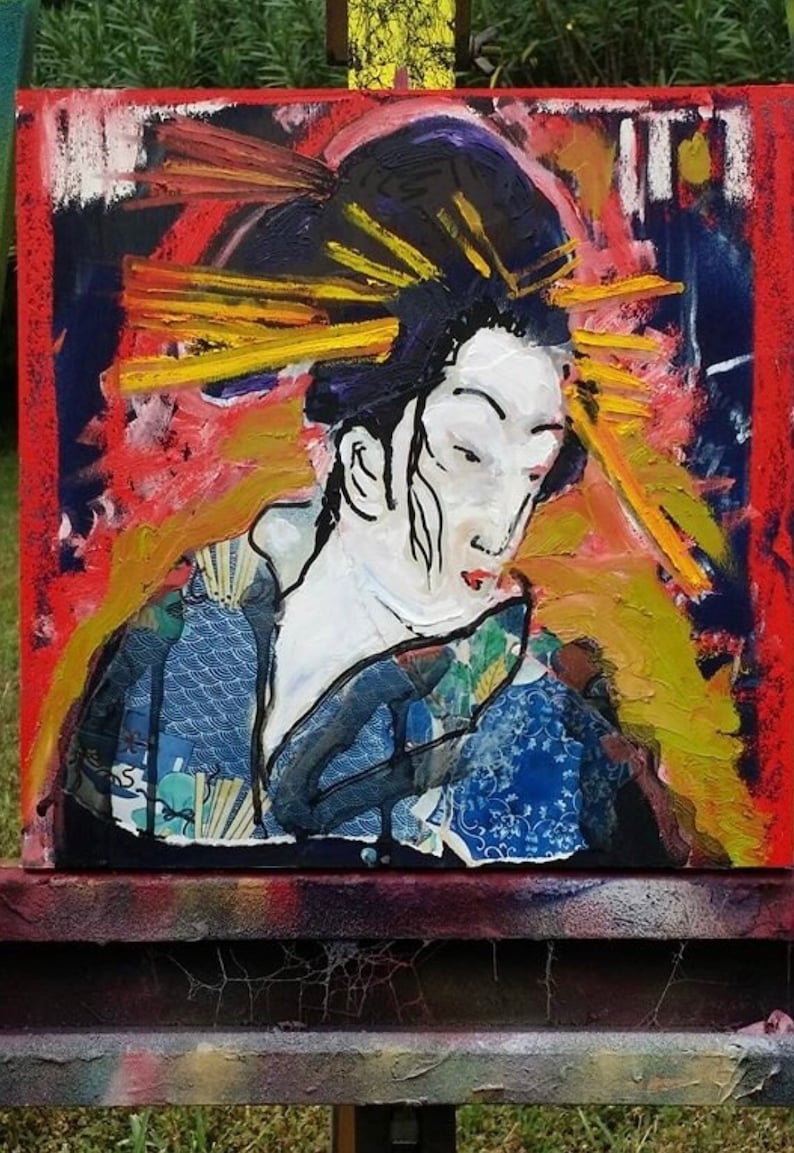 May include: A colorful abstract painting of a woman with a large, yellow and red headdress. The woman is wearing a blue and white patterned kimono. The painting is on a canvas and is displayed on an easel.