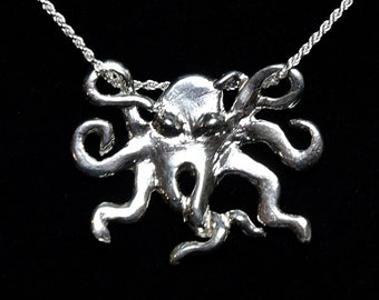 May include: A silver necklace with an octopus pendant. The octopus is detailed and has a realistic design.
