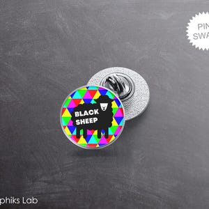 May include: A round pin with a black sheep design. The pin features a black sheep silhouette with the text "BLACK SHEEP" on a colorful geometric background. The pin has a silver backing and a pin clasp.
