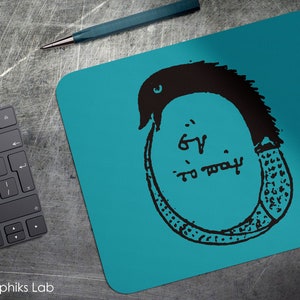 May include: A teal blue mousepad with a black and white illustration of a snake with the text "6' to pray" inside the circle formed by the snake.