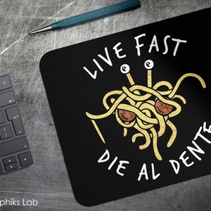 May include: Black mouse pad with a white graphic of a spaghetti monster with the text "Live Fast Die Al Dente".