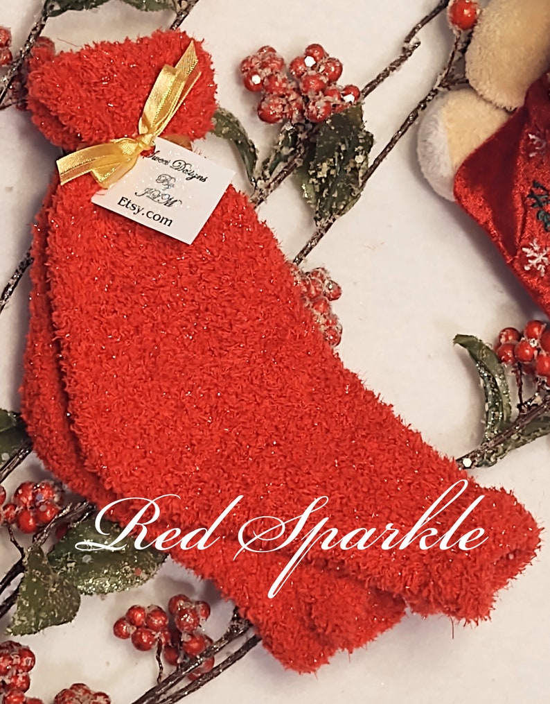 May include: Red fuzzy socks with sparkly threads. The socks are tied with a gold ribbon and a white tag that says "Love Designs Etsy.com".