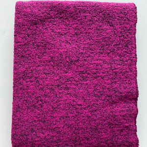 Op de afbeelding: Een zacht, roze en zwart pluche deken.