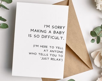 May include: A white card with black text that reads "I'm sorry making a baby is so difficult. (I'm here to yell at anyone who tells you to 'just relax')". The card is sitting on a brown envelope.