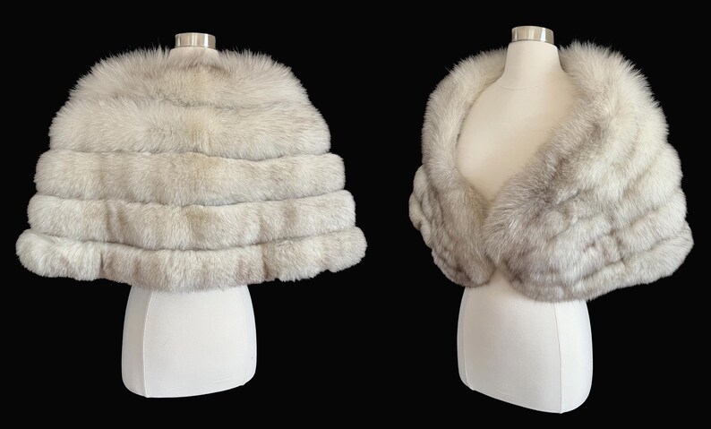 May include: Two views of a luxurious, light gray fur stole. The stole is displayed on a white mannequin, showcasing its layered design and soft texture. The background is a solid black, highlighting the elegance of the garment.
