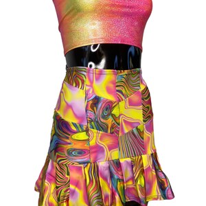 May include: A pink and yellow swirl print mini skirt with a ruffled hem. The skirt is made of a stretchy, comfortable fabric and has a high waist.