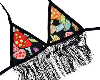 May include: A black triangle-shaped bra with a fringe trim. The bra is made of a black fabric with a colorful mushroom print.