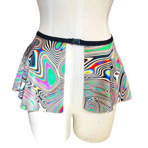 May include: A colourful, psychedelic print skirt with a black elastic waistband and a snap closure. The skirt has a ruffled hem and is made of a stretchy fabric.