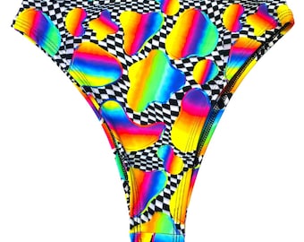 May include: High-waisted swimsuit bottoms with a black and white checkered pattern and colorful abstract shapes.