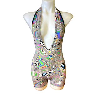 May include: A halter-style bodysuit with a deep V-neckline. The bodysuit is made of a stretchy fabric with a psychedelic swirl pattern in shades of pink, blue, green, yellow, and black.