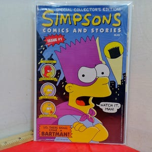 May include: A Simpsons Comics and Stories Issue #1 comic book featuring Bart Simpson dressed as Bartman with a purple mask and cape. The cover includes the text "Special Collector's Edition!", "Watch it, man!", and "Lo, there shall come...a Bartman!" against a blue background.