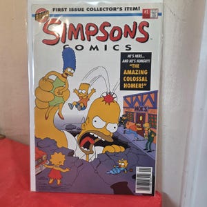 May include: Simpsons Comics issue number 1 featuring a giant Homer Simpson emerging from the ground. The cover shows Marge, Bart, Lisa, and Maggie Simpson with Moe's Tavern in the background. Text reads: First Issue Collector's Item and The Amazing Colossal Homer.