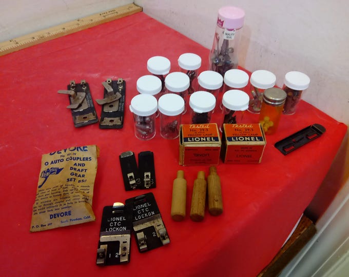 Vintage Train Track and Vehicle Parts, Yellow Lamp Bulb No. 29-3, Auto Couplers, Springs, Holders, and Other Items