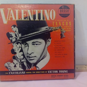 May include: A red and white record album cover featuring a photo of a man in a black hat and a white shirt. The album is titled "Valentino: A Collection of Tangos" and features the text "The Castilians under the direction of Victor Young" and "Decca Album 9-353".