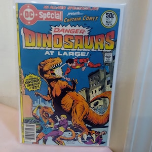 May include: A vintage comic book titled "DC Special" featuring Captain Comet. The cover art depicts a large orange dinosaur attacking a superhero, with the text "Danger! Dinosaurs at Large!" and "Incredible Dinosaur Invasion of 1977!"