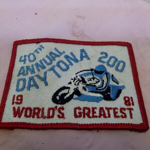 May include: Embroidered patch featuring a motorcycle racer on a blue and white motorcycle. The patch reads "40th Annual Daytona 200" and "World's Greatest" in red and blue lettering. The year "1981" is also displayed.