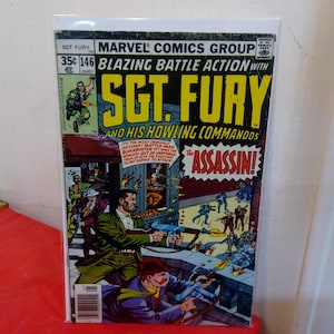 May include: A Marvel Comics Group Sgt. Fury and His Howling Commandos comic book, issue 146, titled The Assassin. The cover features a colorful action scene with characters firing weapons, bold yellow text, and a 35 cent price tag in the corner.