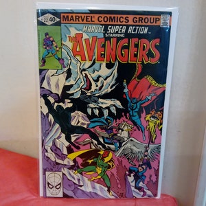 May include: A comic book cover featuring the Avengers, a group of superheroes. The cover is black and red with a white background. The title "The Avengers" is in large, bold letters. The cover features a group of superheroes fighting a large, white, monster-like creature. The cover also features the text "Marvel Super Action" and "Marvel Comics Group".