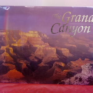 May include: A book cover with a photo of the Grand Canyon. The title of the book is "The Grand Canyon" in gold lettering.