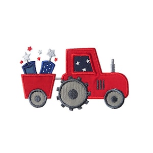 May include: Red toy tractor with a wagon filled with blue and white fireworks. The tractor has a gray tire and a black grill.