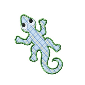 May include: A blue and green embroidered patch of a cartoon lizard with large eyes.