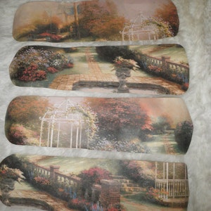 May include: Four decorative ceiling fan blades with a garden scene. The blades feature a white gazebo, a stone fountain, and lush greenery with flowers in shades of pink, purple, and blue.