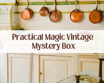 May include: A kitchen scene featuring copper pans hanging above a white cabinet. The text "Practical Magic Vintage Mystery Box" is displayed. The table is set with plates, silverware, and candle holders.